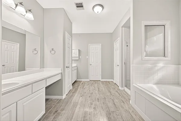 a bathroom with a bathtub and a sink