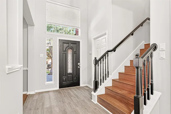 a view of an entryway with wooden floor