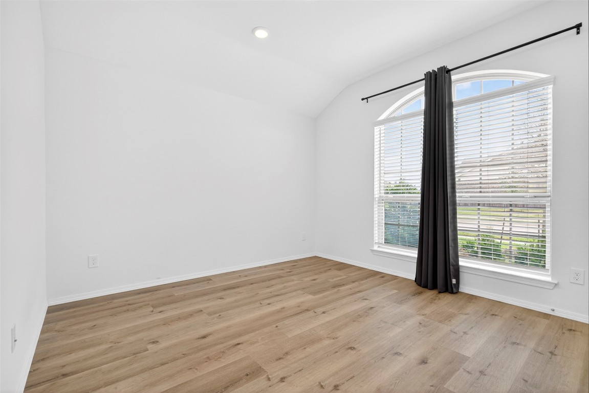 5402 Still Creek Ranch Drive Richmond, TX 77469 - Photo 23 of 32 an empty room with wooden floor and windows