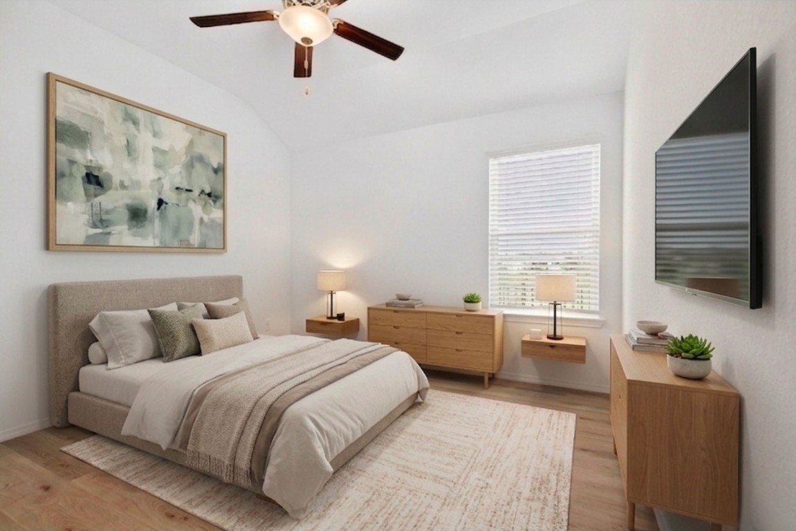 5402 Still Creek Ranch Drive Richmond, TX 77469 - Photo 5 of 32 a bedroom with a bed a couch and a chandelier
