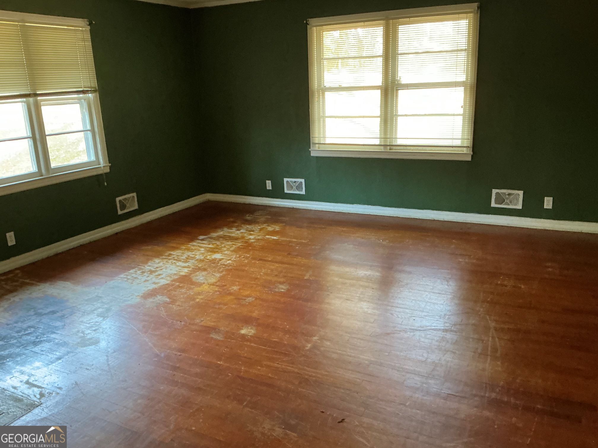 135 Brookside Drive Elberton, GA 30635 - Photo 5 of 22 an empty room with wooden floor and windows