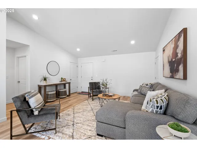 a living room with furniture a rug and a window