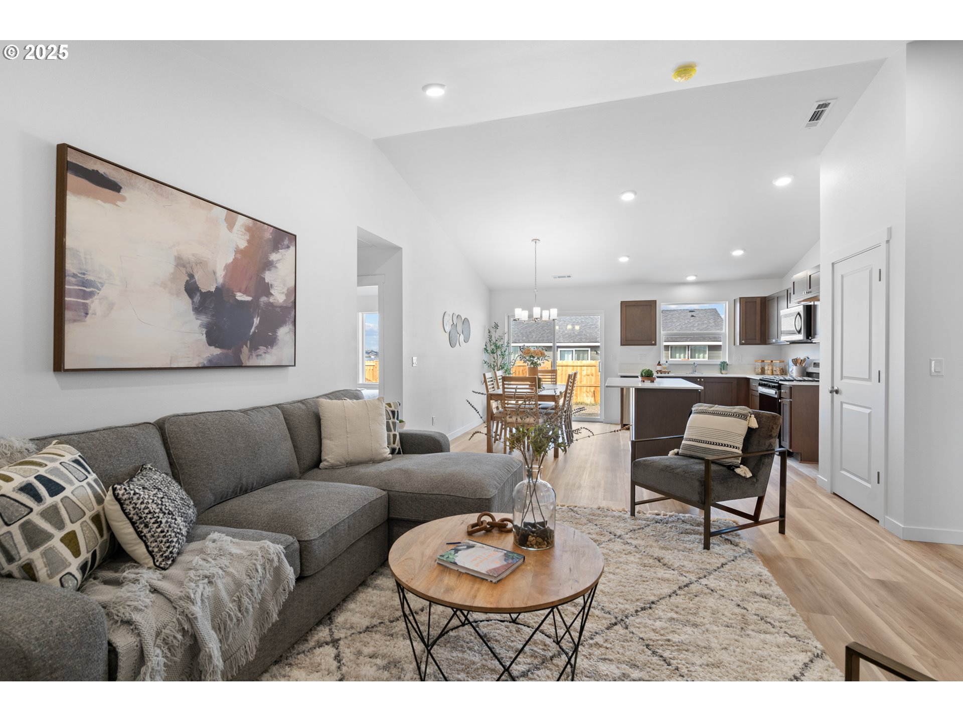 218 Southwest Sparrow Street Boardman, OR 97818 - Photo 14 of 23 a living room with furniture and kitchen view with wooden floor
