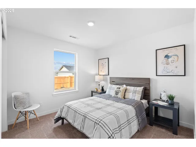 a bedroom with a bed and a chair