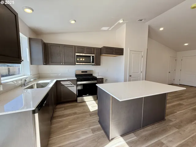 a kitchen with a stove a sink and a refrigerator
