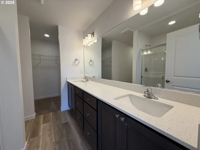 a bathroom with a sink double vanity and a mirror