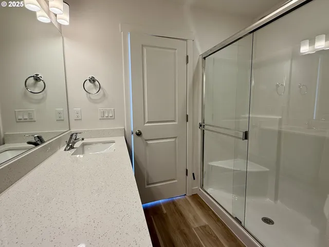a bathroom with a tub a sink and shower