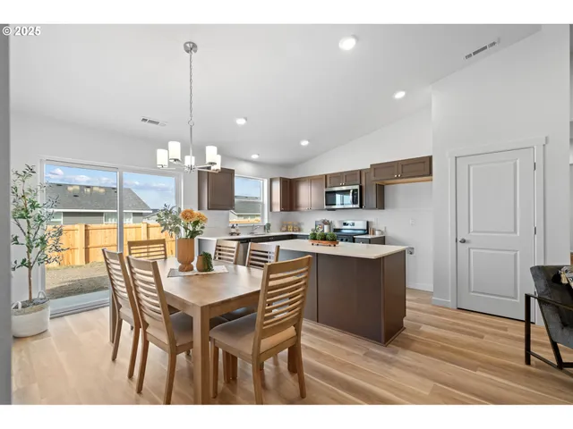 a kitchen with a table and chairs in it