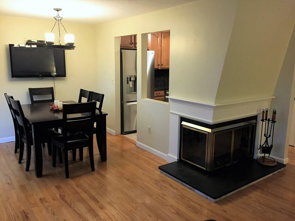 208 B Ridgefield Circle, Unit B Clinton, MA 01510 - Photo 6 of 24 a view of a dining room with furniture and wooden floor