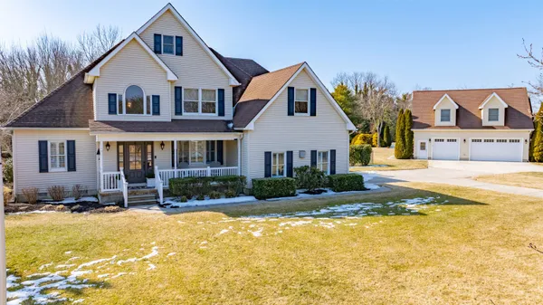 a view of a yard in front of a brick house with a small yard
