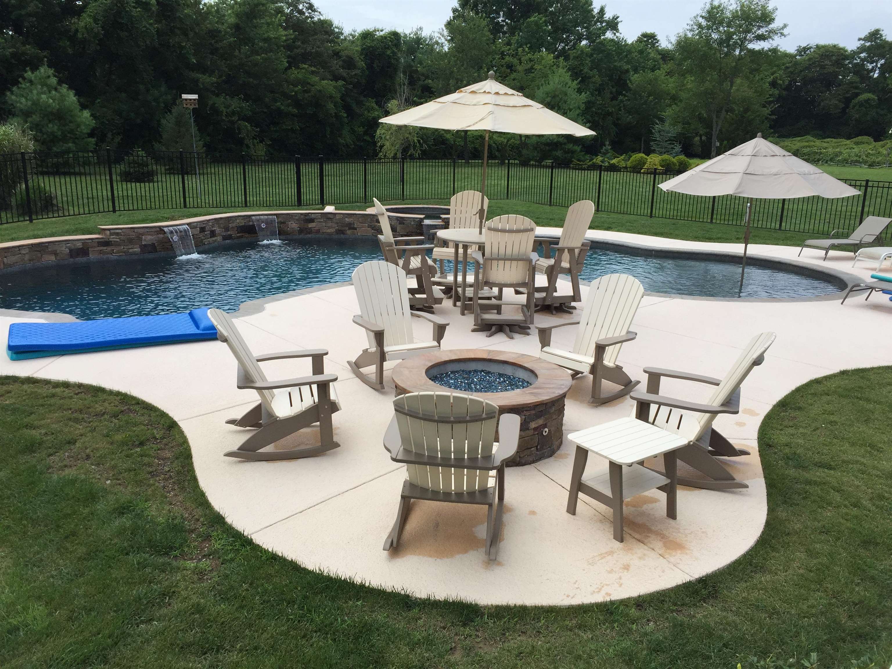 23 Taylor Cold Spring Cape May, NJ 08204 - Photo 47 of 50 a view of a swimming pool with a table and chairs under an umbrella