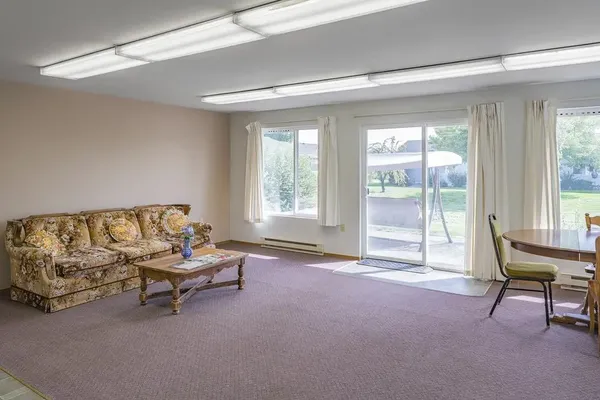 a living room with furniture and a large window