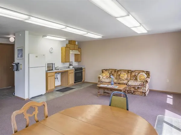 a living room with furniture and kitchen view
