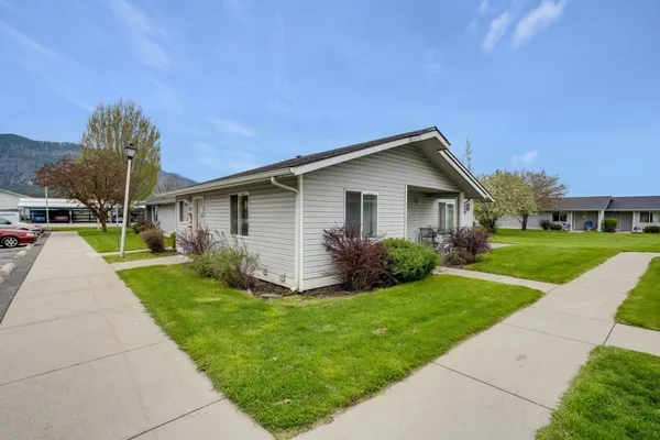 a front view of house with yard and green space