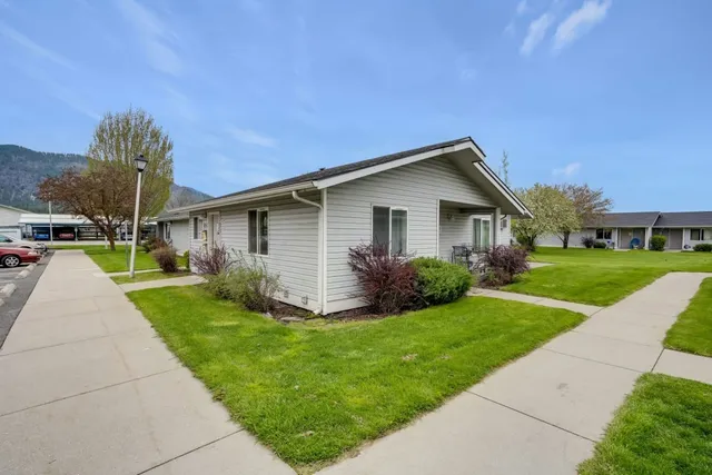 a front view of house with yard and green space