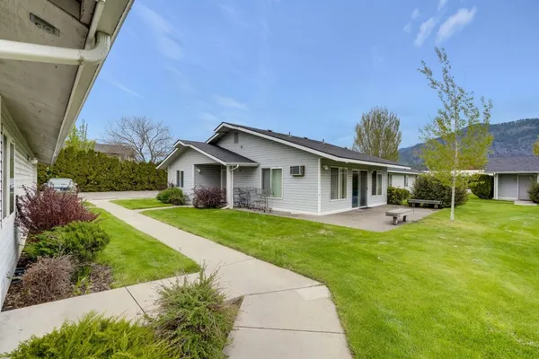 a front view of house with yard and green space