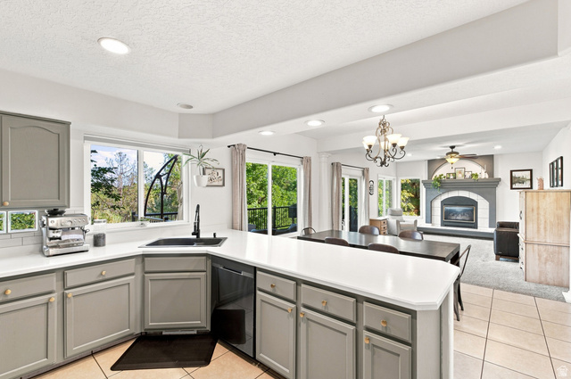 11882 Pond Ridge Drive Draper, UT 84020 - Photo 11 of 49 Kitchen featuring light gray cabinetry, white countertops, subway tile backsplash, and a corner sink