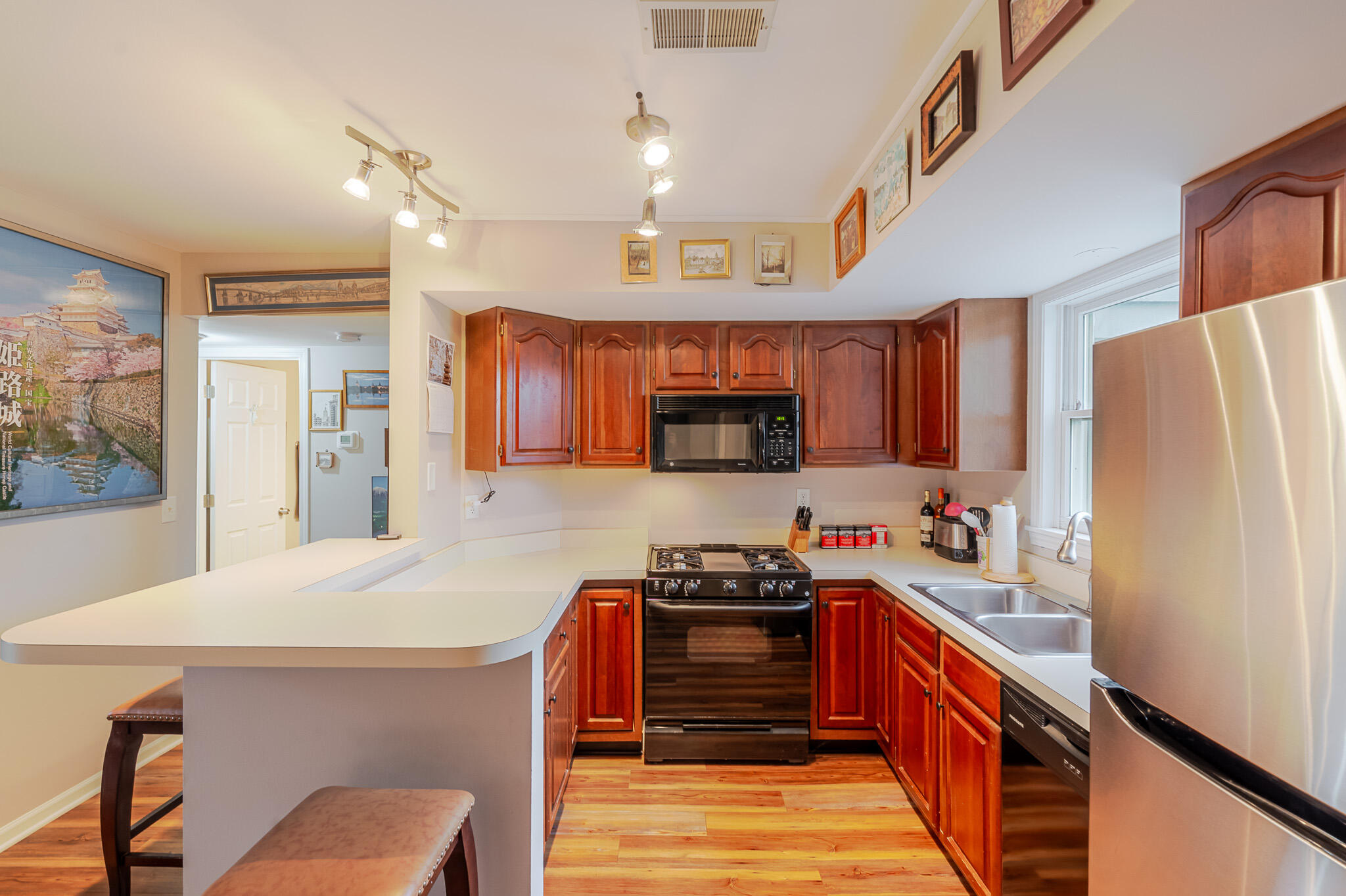 1300 Winding Ridge Lane, Unit A7 Valparaiso, IN 46383 - Photo 12 of 32 a kitchen with stainless steel appliances a sink a stove a refrigerator cabinets and a dining table