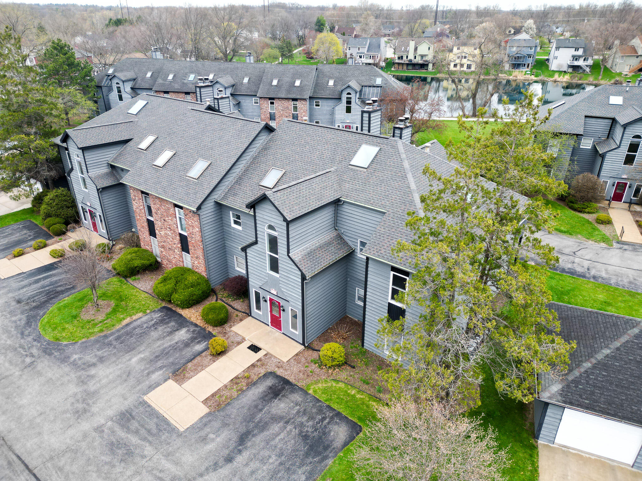 1300 Winding Ridge Lane, Unit A7 Valparaiso, IN 46383 - Photo 31 of 32 an aerial view of a house with a yard potted plants and large trees