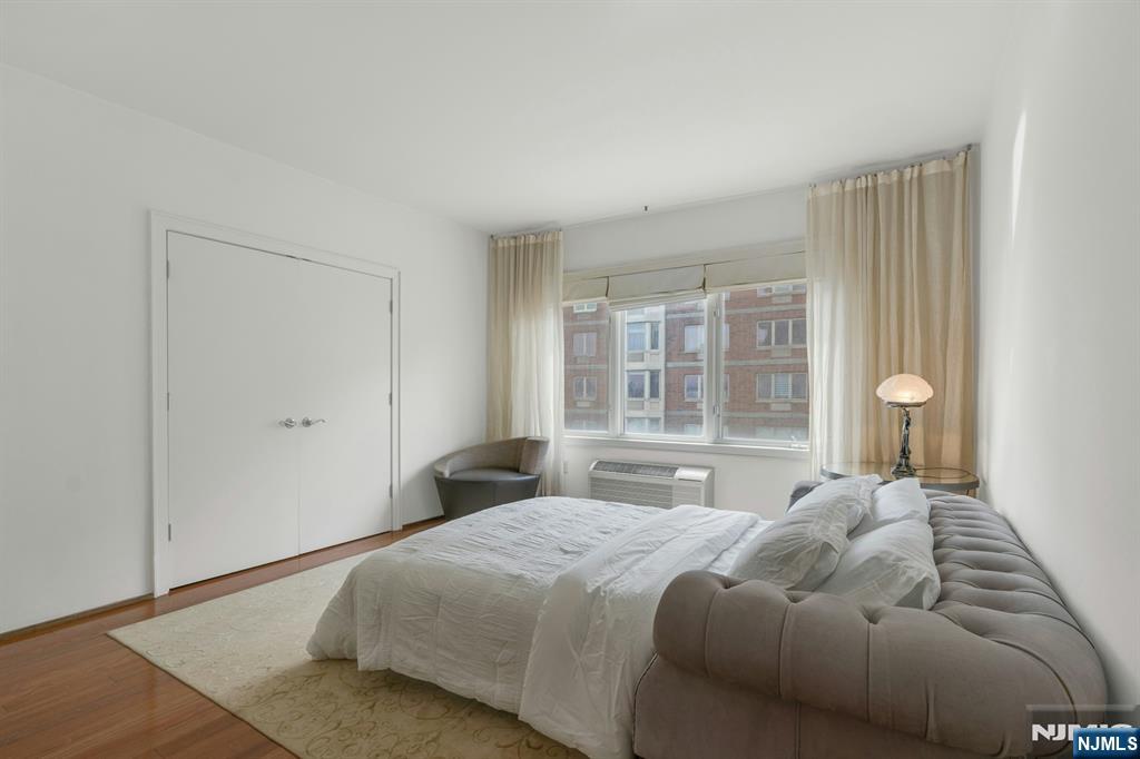 3219 City Place Edgewater, NJ 07020 - Photo 16 of 30 a bedroom with a large bed and wooden floor