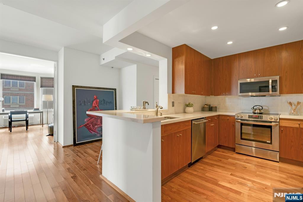 3219 City Place Edgewater, NJ 07020 - Photo 6 of 30 a kitchen with a sink cabinets and wooden floor