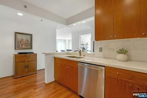 a spacious bathroom with a granite countertop sink and a mirror