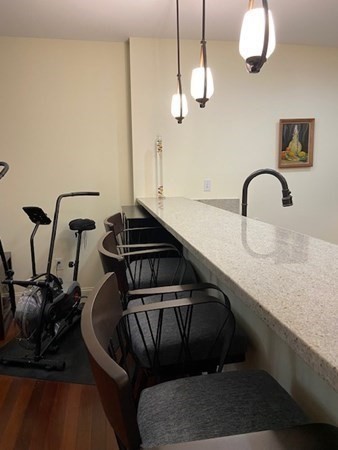 116 Rantoul Street, Unit 408 Beverly, MA 01915 - Photo 12 of 27 a kitchen with a sink and a stove with wooden floor