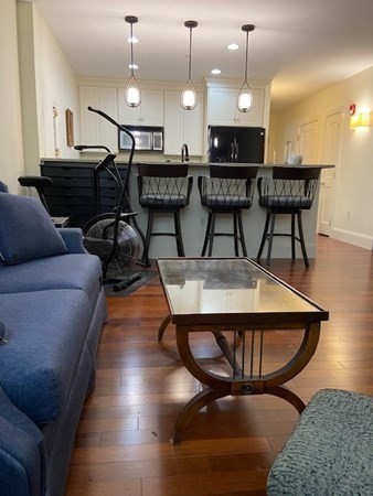 116 Rantoul Street, Unit 408 Beverly, MA 01915 - Photo 14 of 27 a view of a livingroom with furniture and wooden floor