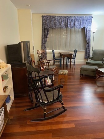 116 Rantoul Street, Unit 408 Beverly, MA 01915 - Photo 16 of 27 a dining room with furniture and wooden floor