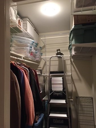 116 Rantoul Street, Unit 408 Beverly, MA 01915 - Photo 18 of 27 a view of walk in closet with clothes and shoes