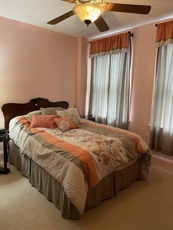 116 Rantoul Street, Unit 408 Beverly, MA 01915 - Photo 22 of 27 a bed sitting in a bedroom next to a window