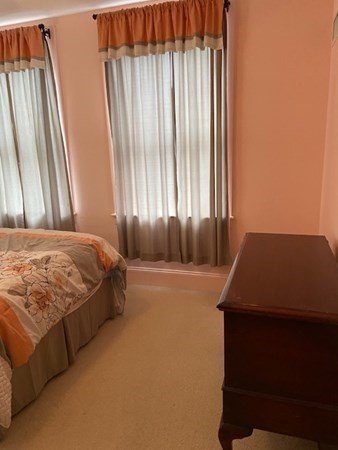 116 Rantoul Street, Unit 408 Beverly, MA 01915 - Photo 23 of 27 a bedroom with a bed and a window
