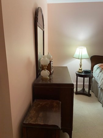 116 Rantoul Street, Unit 408 Beverly, MA 01915 - Photo 24 of 27 a living room with furniture and a lamp