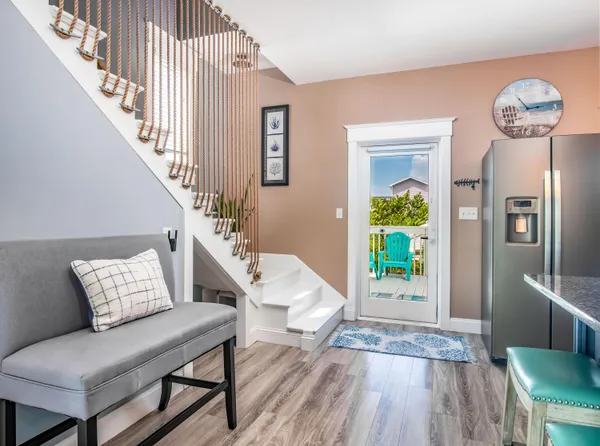 a kitchen with stainless steel appliances granite countertop a table chairs and a refrigerator