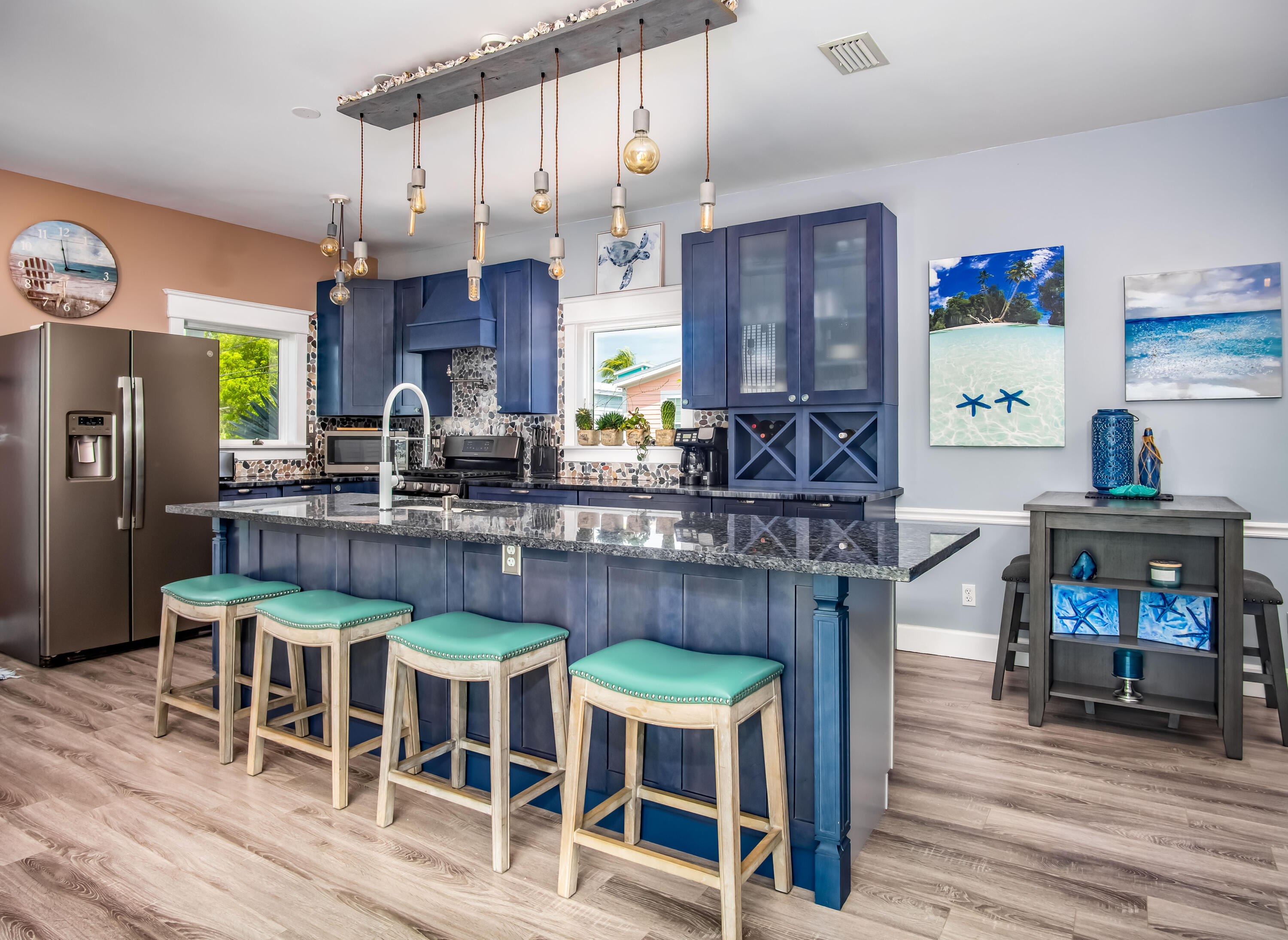 6 Shore Drive Key West, FL 33040 - Photo 20 of 45 a kitchen with stainless steel appliances granite countertop a table chairs and a refrigerator