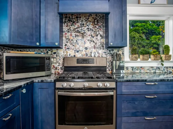 a kitchen with stainless steel appliances granite countertop a sink and a counter space