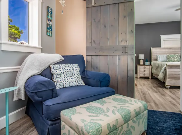a bedroom with furniture and a floor to ceiling window
