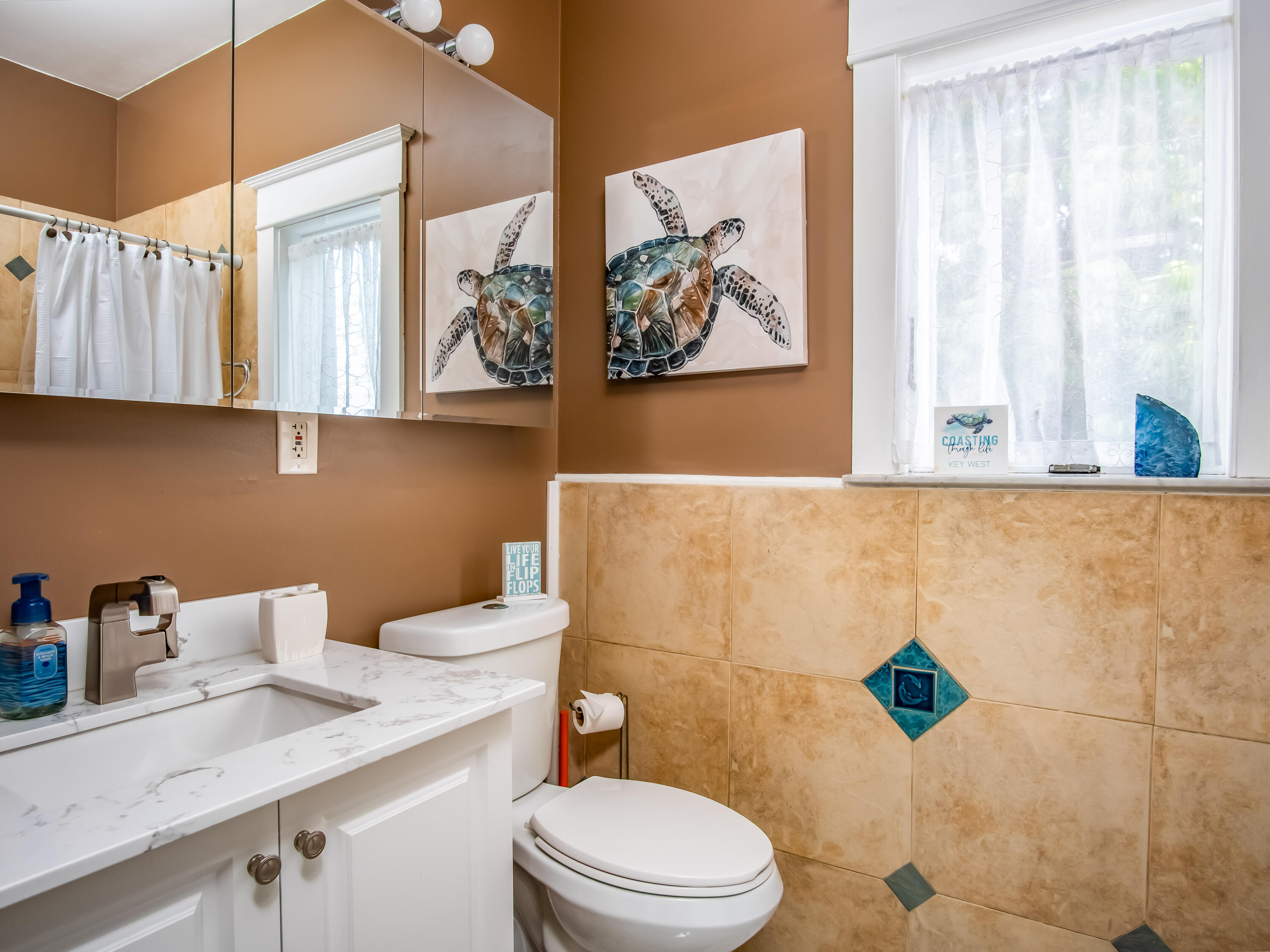 6 Shore Drive Key West, FL 33040 - Photo 33 of 45 a bathroom with a sink a toilet and a shower curtain