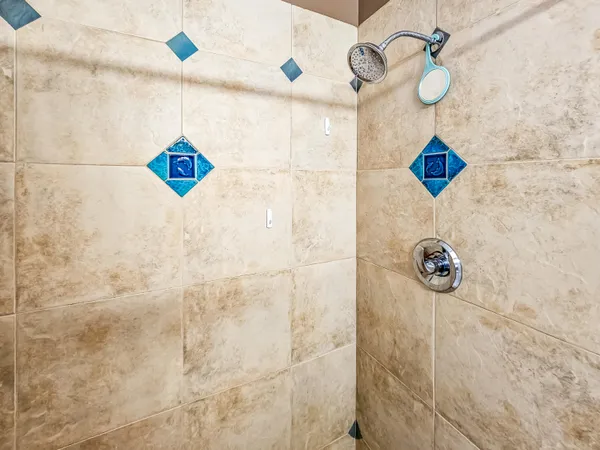 a bedroom with a bed and painting on the wall