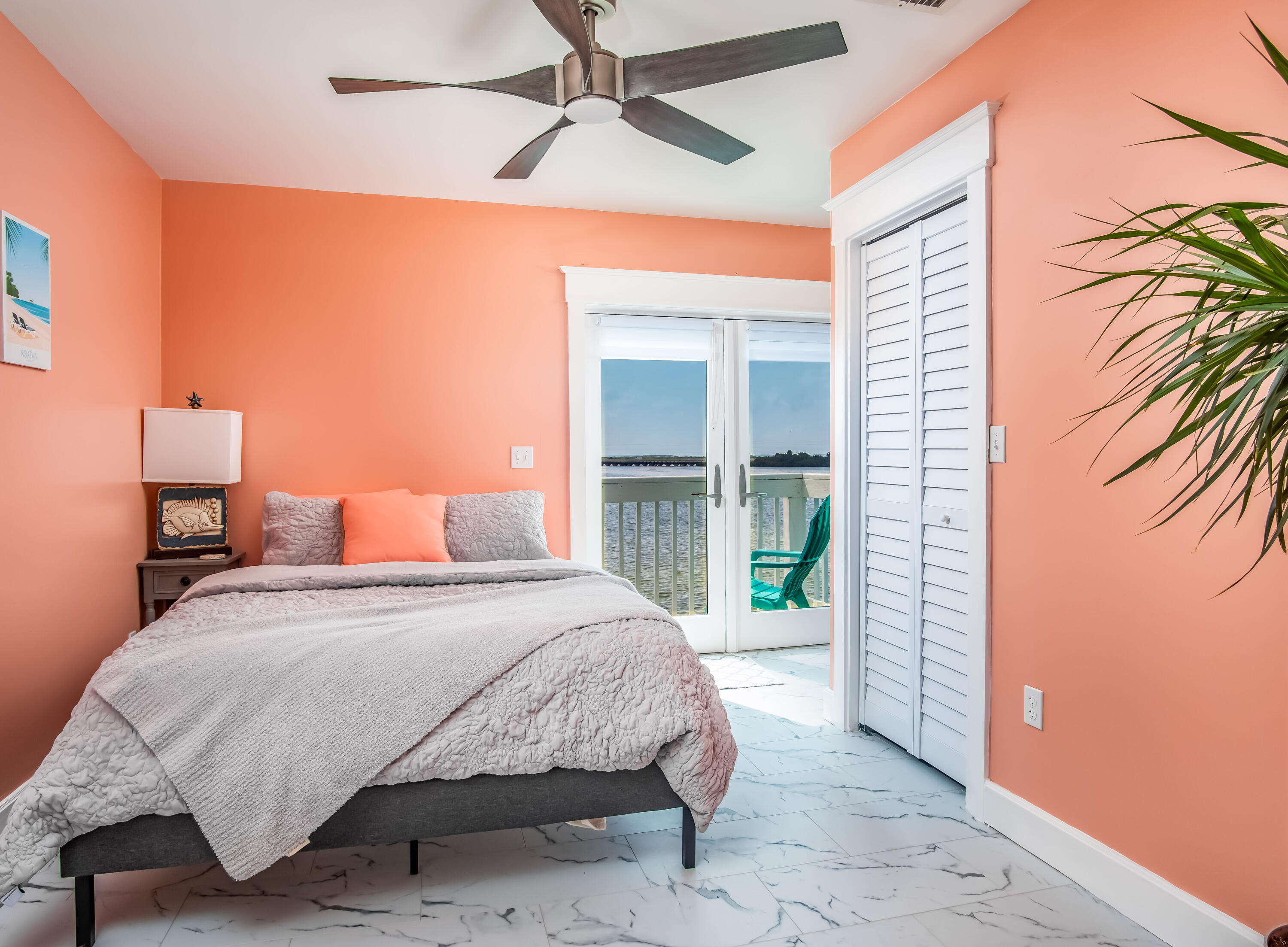 6 Shore Drive Key West, FL 33040 - Photo 42 of 45 a bedroom with a large bed and a chandelier