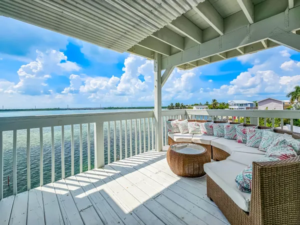 a view of a chair and table on the deck
