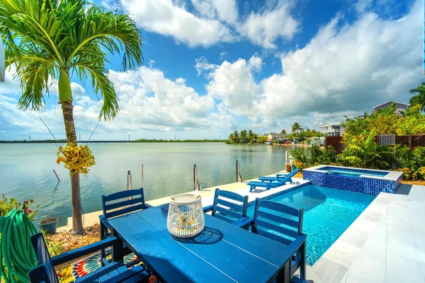 a view of a lake with a table and chairs