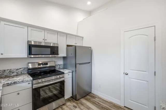 a bathroom with a granite countertop sink and mirror