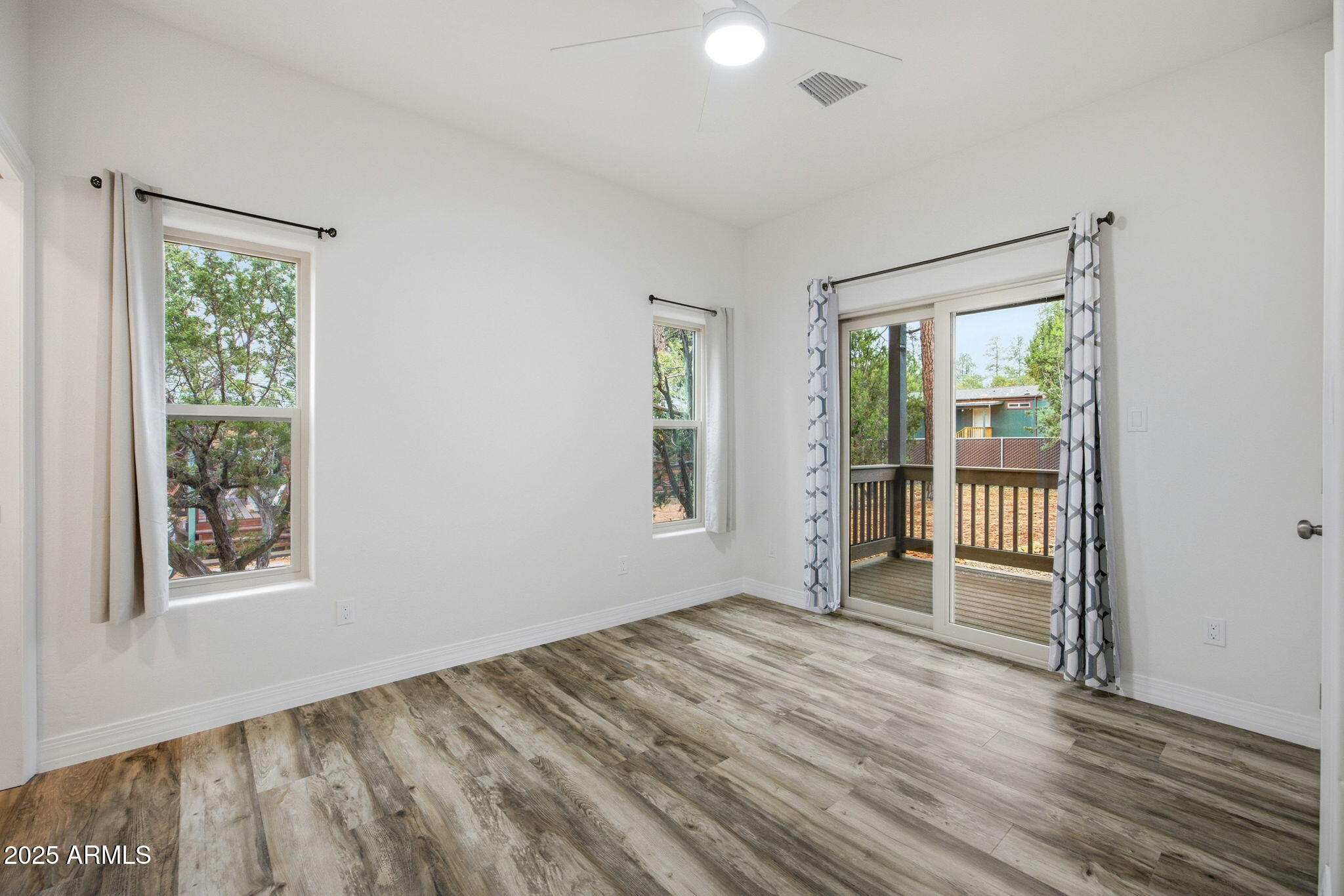 1979 Christmas Pine Road Overgaard, AZ 85933 - Photo 11 of 33 a view of an empty room with wooden floor and a window
