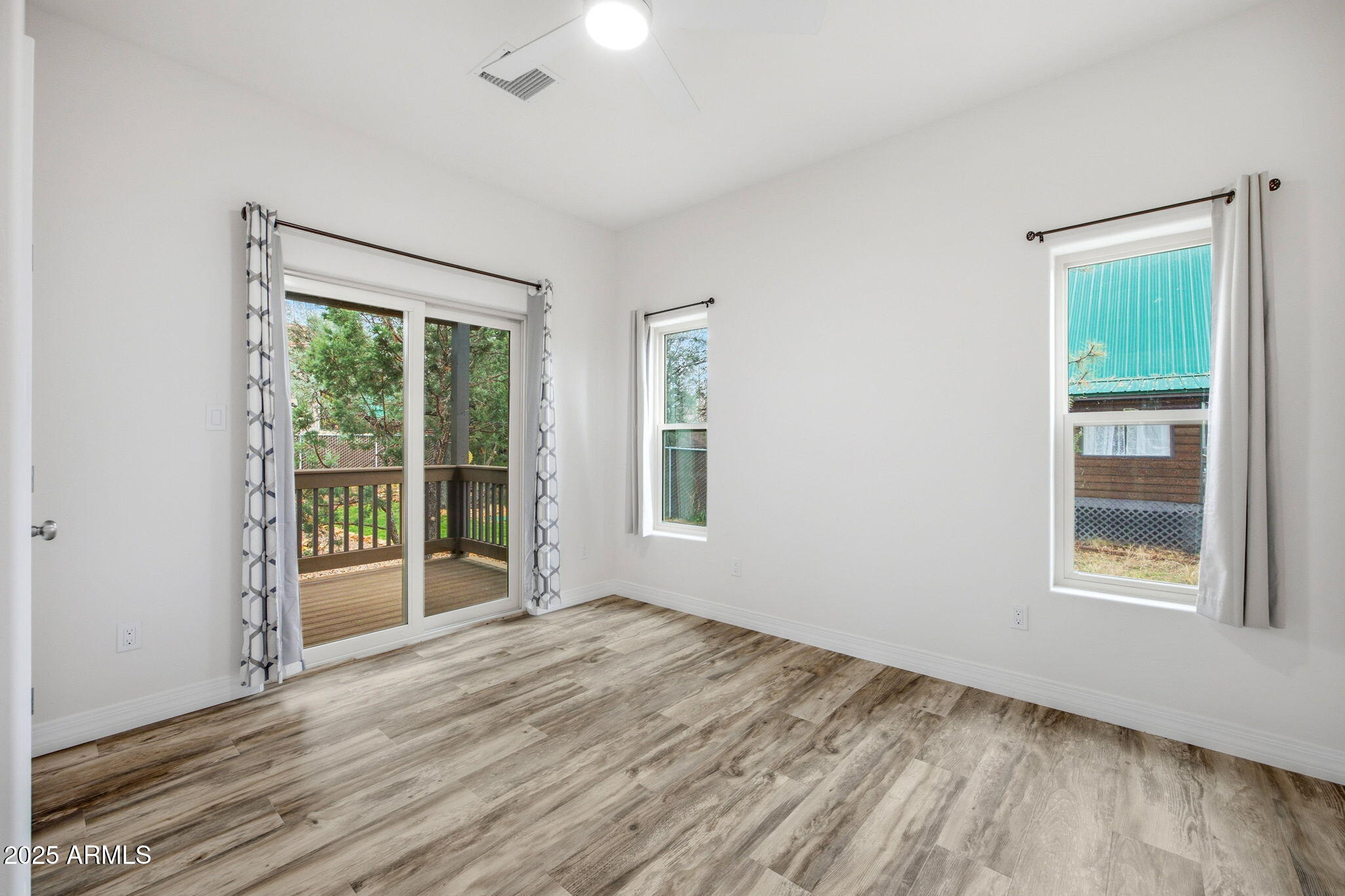 1979 Christmas Pine Road Overgaard, AZ 85933 - Photo 15 of 33 a view of an empty room with wooden floor and a window
