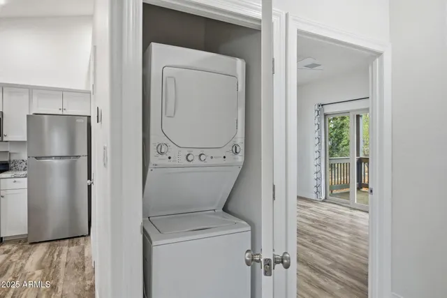 a view of a room with wooden floor and a sink