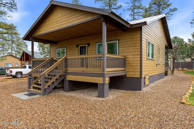 a yellow and white house sitting in front of a house