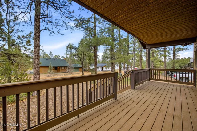 a view of backyard with deck and outdoor seating