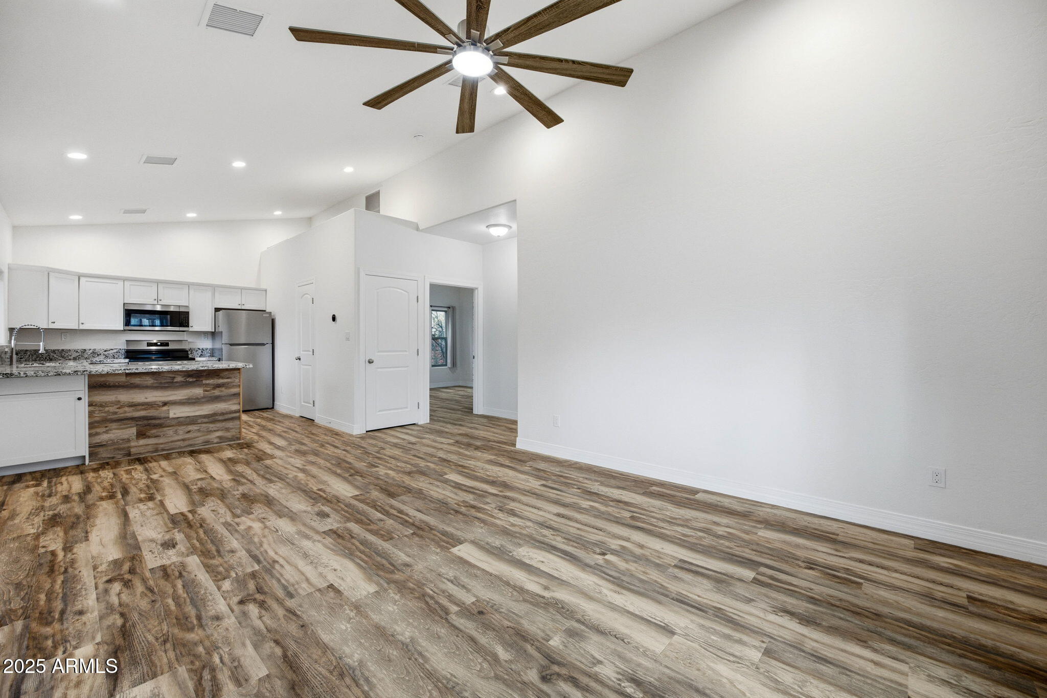 1979 Christmas Pine Road Overgaard, AZ 85933 - Photo 7 of 33 a view of kitchen and empty room with wooden floor