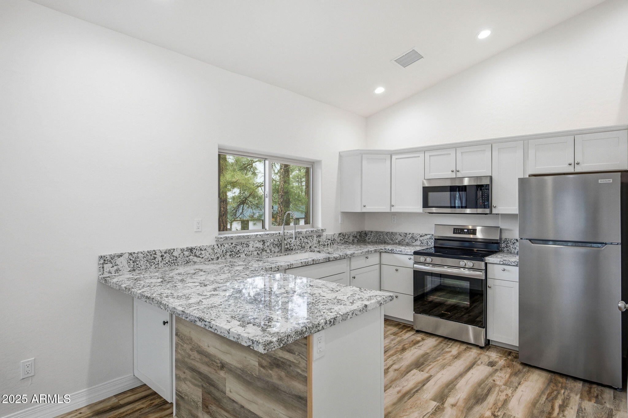 1979 Christmas Pine Road Overgaard, AZ 85933 - Photo 8 of 33 a kitchen with stainless steel appliances granite countertop a sink stove and refrigerator